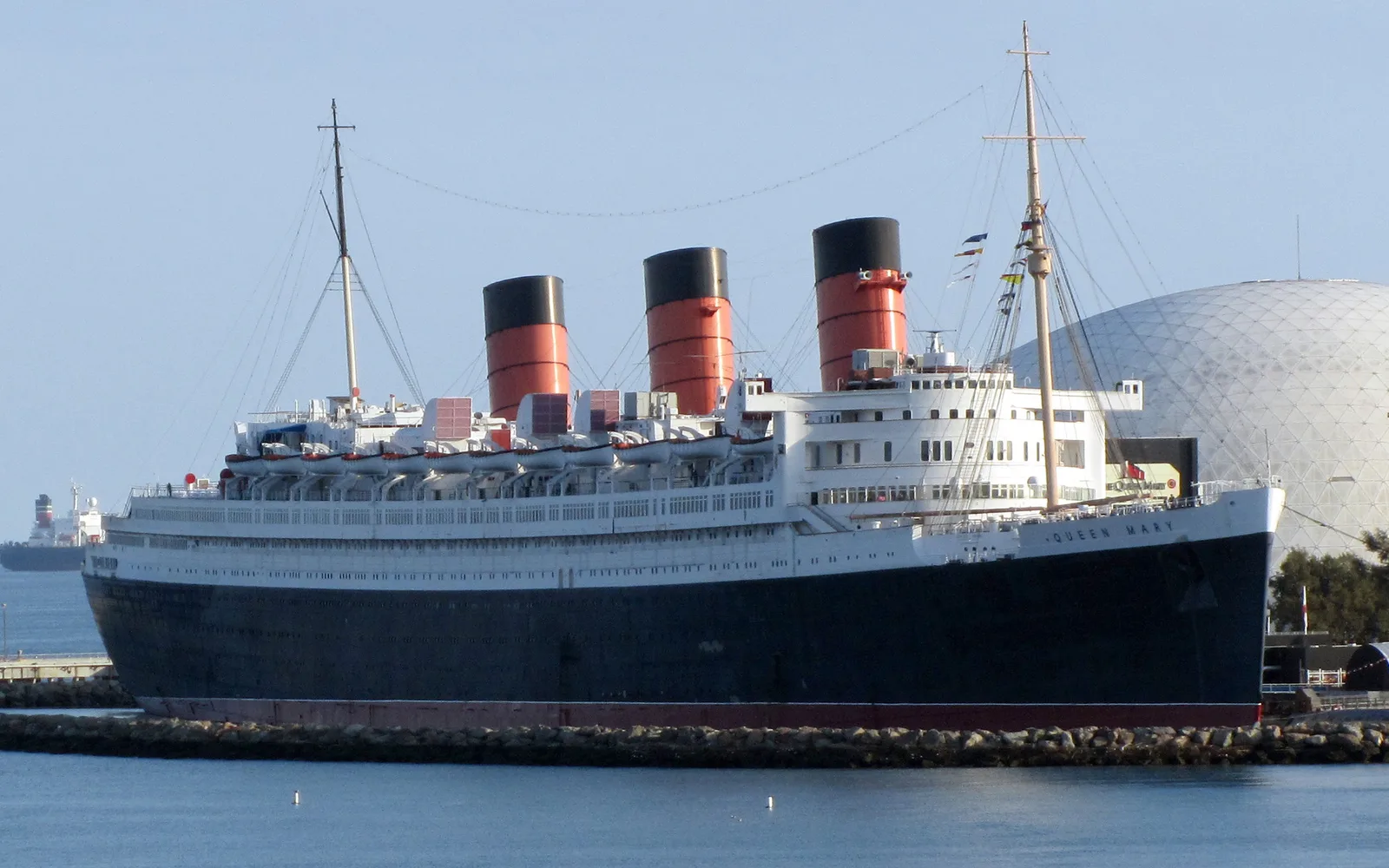 The RMS Queen Mary ocean liner permanently moored in Long Beach harbor, viewed from the waterfront